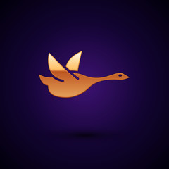 Wall Mural - Gold Flying duck icon isolated on dark blue background. Vector Illustration