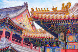 Chinese traditional architecture -  colorful ornament and statue dragons on roof of Lama Temple in Beijing, China