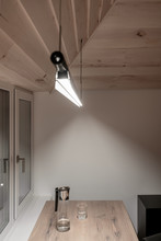 Light Illuminated Interior With Sloping Wooden Ceiling