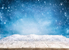 Beautiful Winter Background With Wooden Old Desk And Blurred Blue Sky. Winter, New Year And Christmas Concept With Snowy Background.