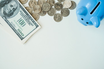 Wall Mural - Piggy bank, coins and stack of dollar bills on background with copy space.