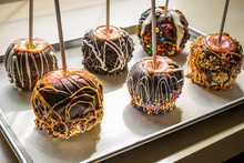 Gourmet Caramel Apples Covered In Chocolate And Assorted Nuts And Candy Pieces