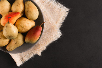 Wall Mural - Fresh juicy appetizing pears on a gray plate, summer concept, copy space.