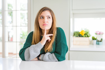 Poster - Young beautiful plus size woman wearing casual striped sweater Thinking concentrated about doubt with finger on chin and looking up wondering