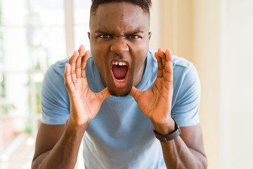 Poster - African american man shouting with rage, yelling excited with hand on mouth