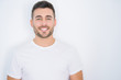 © Krakenimages.com - Young handsome man smiling happy wearing casual white t-shirt over white isolated background