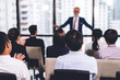 © Art_Photo - Businessman standing in front of group of people in consulting meeting conference seminar at hall or seminar room.presentation and coaching concept