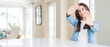 © Krakenimages.com - Wide angle picture of beautiful young woman sitting on white table at home Smiling doing frame using hands palms and fingers, camera perspective