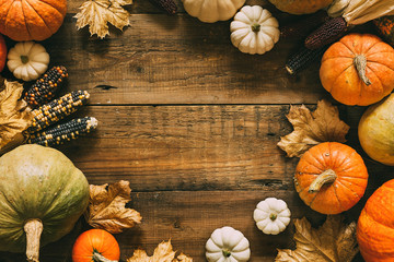 Wall Mural - different pumpkins on wooden surface with copy space.