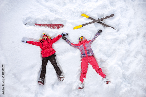 Cuadros en Lienzo Aerial photo of skier and snowboarder lying on snow