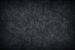 © prapann - Dark grey black slate background or texture.