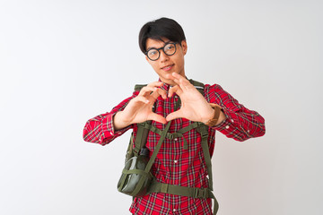 Sticker - Chinese hiker man wearing backpack canteen glasses over isolated white background smiling in love doing heart symbol shape with hands. Romantic concept.