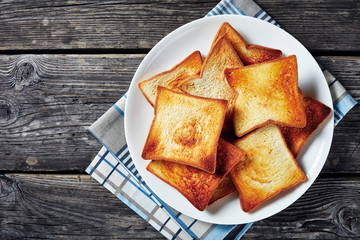 Wall Mural - toasts of wheat bread on a white plate