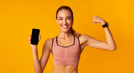 Girl Holding Smartphone Showing Muscles On Yellow Background, Mockup, Panorama