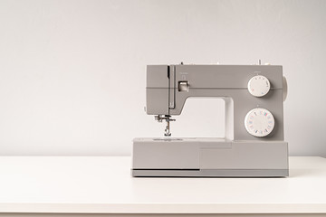 sewing machine on tailor table with copy space