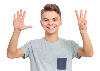 Wall Mural - Portrait of happy teen boy showing two palms - 8 fingers, isolated on white background. Happy smiling child doing gesture of number Eight. Series of photos count from 1 to 10.