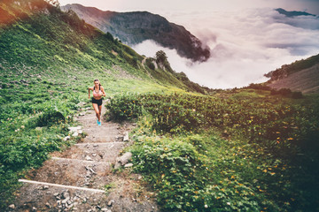 Woman running and jogging in the nature mountain scenery. Concept of healthy lifestyle. Fitness spot girl training in mountain.