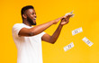 © Prostock-studio - Happy african american guy throwing out money banknotes