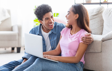 Wall Mural - Cheerful teenagers chatting with friends online, typing on laptop