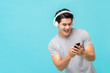© Atstock Productions - Smiling Asian man wearing wireless headphones listening to music