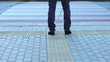 © motortion - Lone blind man detecting tactile tiles, walking to pedestrian crossing safe road