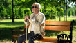 © motortion - Blind man sitting on bench, listening for sounds in park, heightened senses