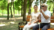 © motortion - Positive woman and blind man spending time on bench in park, support and care