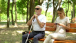 © motortion - Blind man sitting on bench, healthy lady using phone instead enjoying nature