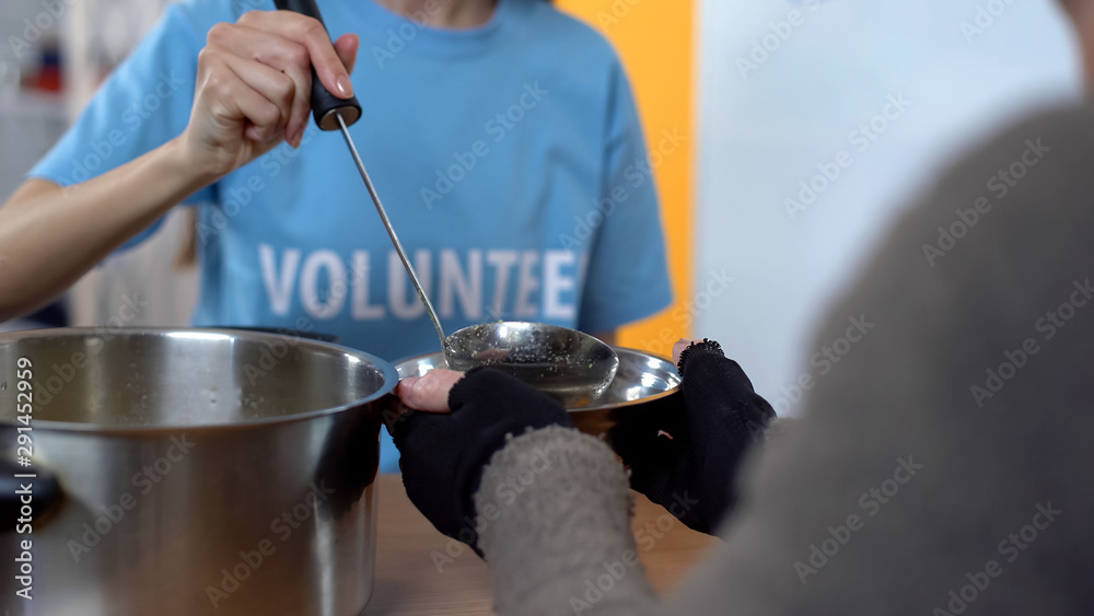 Charity project, female volunteer serving soup in shelter, care of poor people - obrazy, fototapety, plakaty 