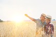 © MDBPIXS - Mature showing wheat field to senior farmer with yellow lens flare in background