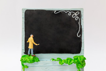 Canvas Print - Miniature people : Painter holding a brush with  space for text