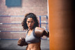 © ReeldealHD images - Female boxer punching a punch bag