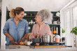 © ReeldealHD images - Senior adult woman cooking a meal with daughter