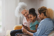 © ReeldealHD images - Granddaughter showing grandmother how to use smartphone