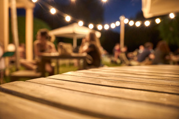 view of a wooden table on the terrace of a bar