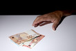 © Andrea - man's hand grabbing some Euro banknotes with copy space for your text