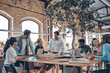 © gstockstudio - Group of young modern people in smart casual wear communicating and using modern technologies while working in the office