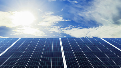 Wall Mural - eco technology solar panel with sun and blue sky background. concept clean energy in nature