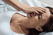 © LIGHTFIELD STUDIOS - stressed young woman lying on bed at home