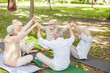 © Yakobchuk Olena - Old people sitting in healing circle and holding hands