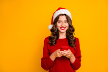 Photo Of Amazing Lady Holding Telephone In Hands Wear Knitted Pullover And Santa Hat Isolated Yellow Background