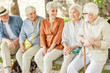 © Yakobchuk Olena - Cheerful senior people sitting on bench and chatting