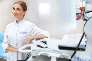 Wall Mural - Smiling young specialist in ultrasound office stock photo