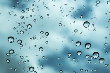 Rain on the window, natural skin of the rain The natural form of rainwater on a sky background.