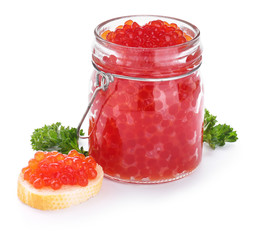 Jar with red caviar and bread on white background