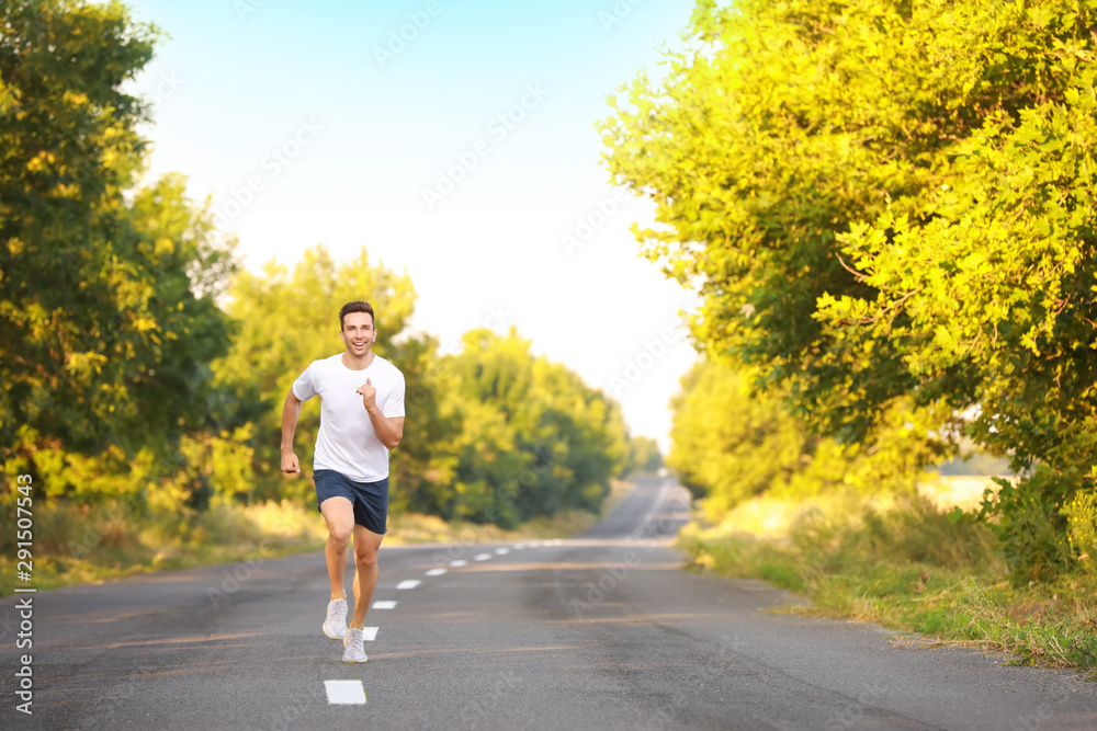 Sporty young man running outdoors