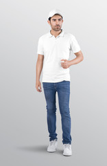 Wall Mural - Male model wearing white plain polo t shirt in blue denim jeans pant. Isolated background