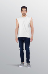 Wall Mural - Fitness young guy model wearing white plain sports sleeveless shirt in dark blue denim jeans pant. Isolated background