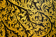 © MergeIdea - Thai traditional gorgeous pattern painting Lai Kanok sparkling golden exquisite tracery ancient beautiful art on black background interior decoration indoor at historical monument religious temple