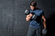 © Srdjan - Young strong muscular sweaty man biceps muscle workout training with heavy dumbbell weight in the gym dark image with shadows real people